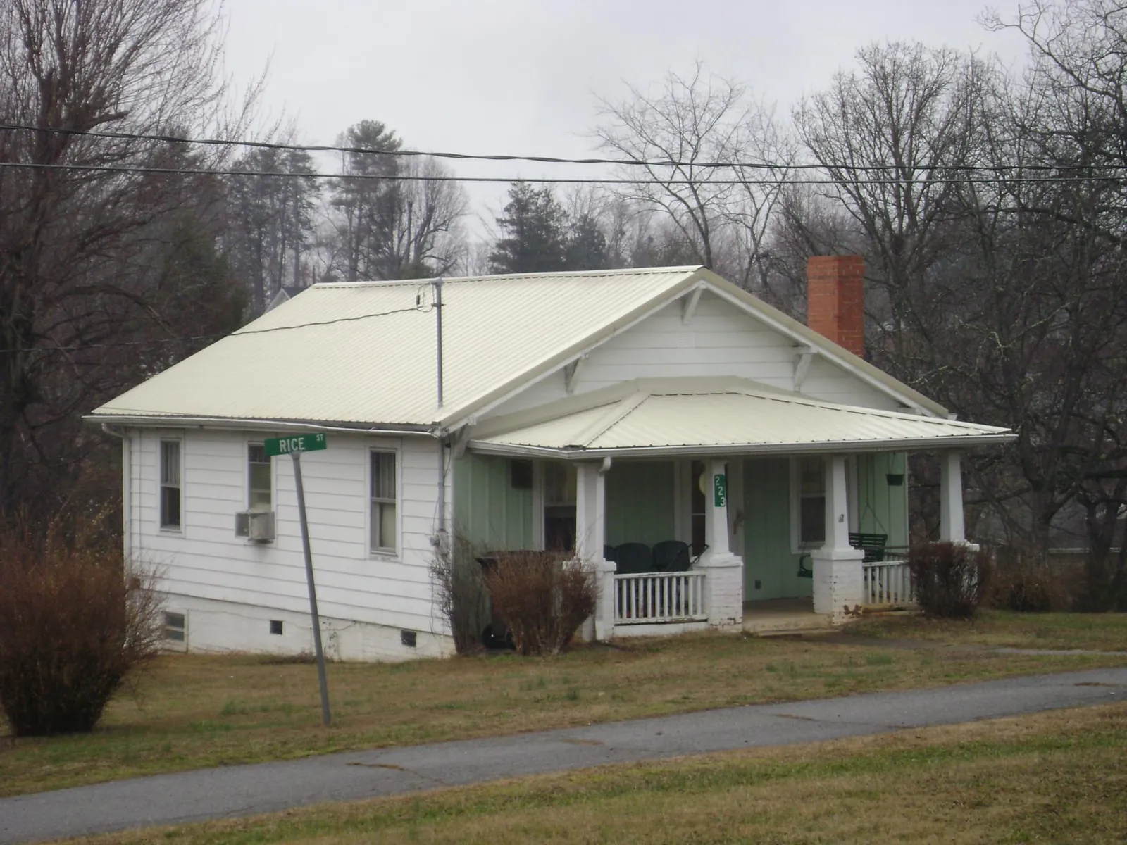 White metal roof on a craftsman bungalow at a street corner in Green Bay